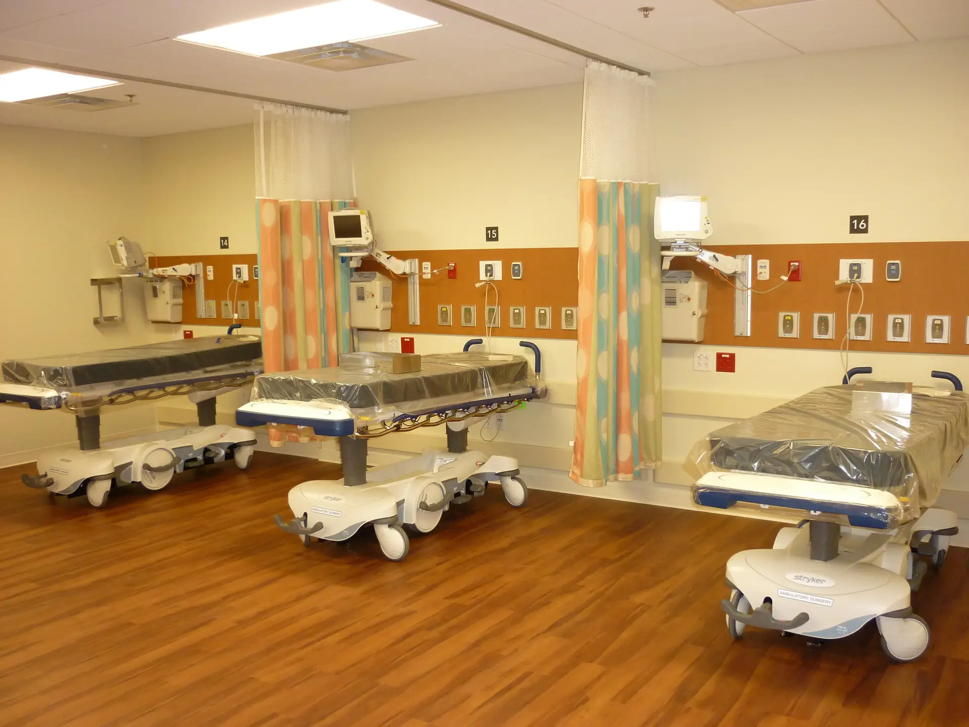 Clinic bays with beds and curtains